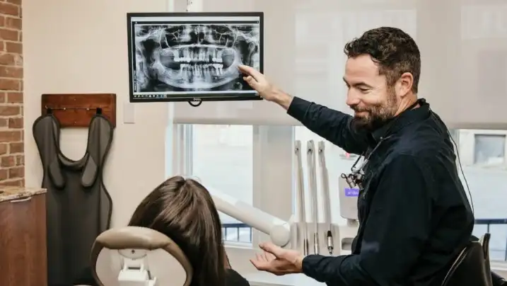 Dentist at Front Street Dental reviewing a dental x-ray with a patient